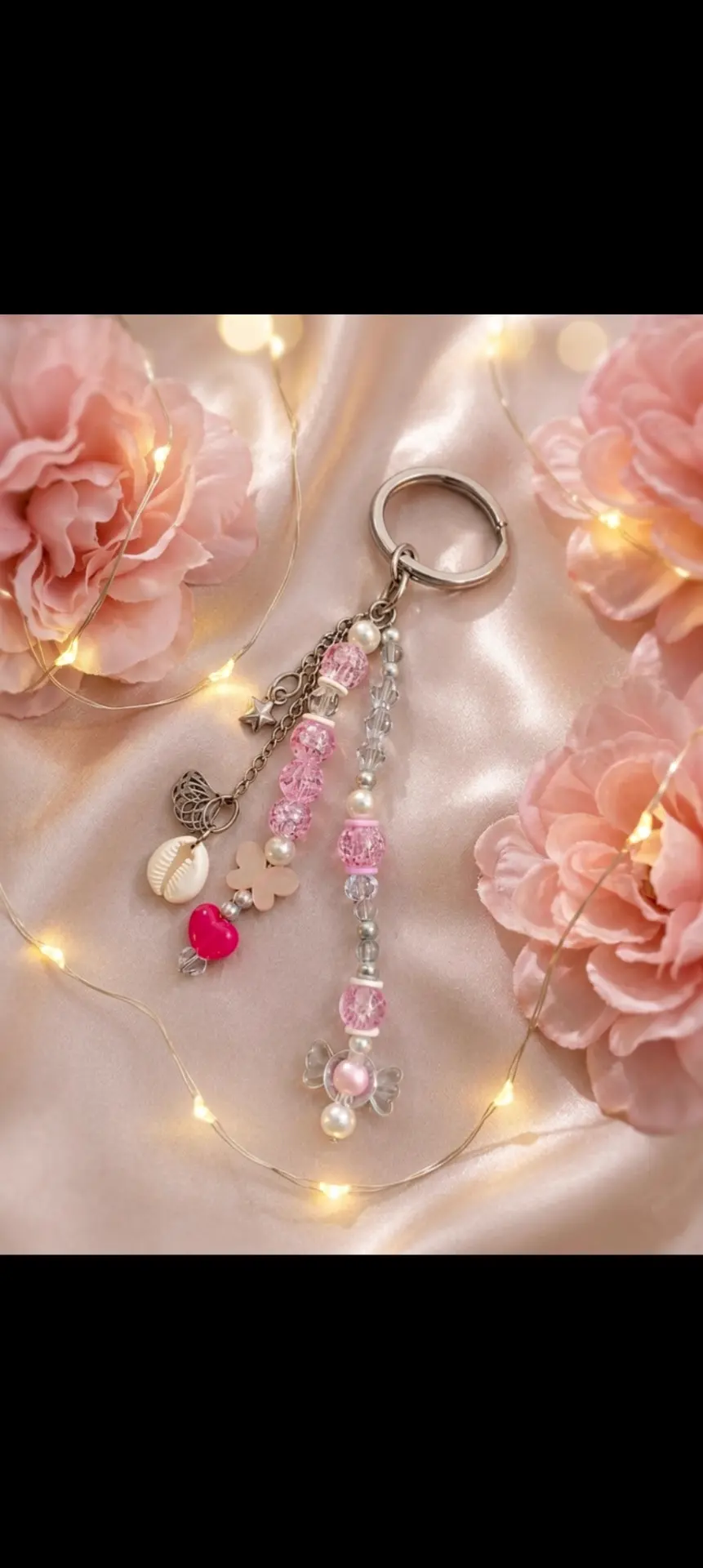 Handmade pink beaded keychain with cowrie shell and butterfly charm by Beads Berry